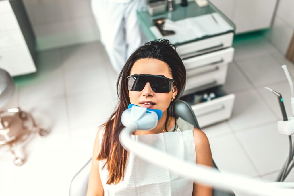 Woman getting professional teeth whitening